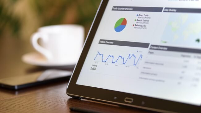 A person holding a digital tablet displaying a PDF document. — cheap PDF strategy, sell digital products