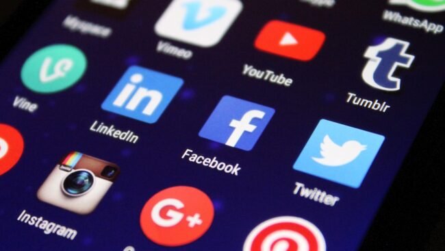 A person promoting their book on social media using a smartphone.