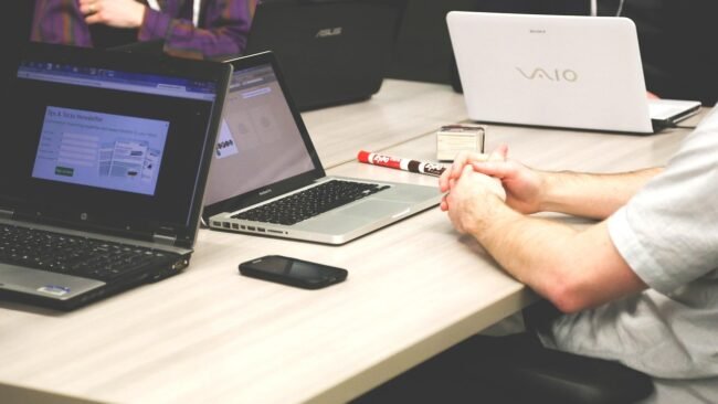 A team discussing value propositions in a modern office setting. — sell your course successfully
